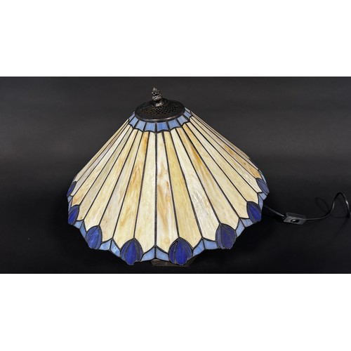 112 - A Tiffany style lamp with a conical shaped “lead” segmented glass shade and two pyramid Tiffany styl... 