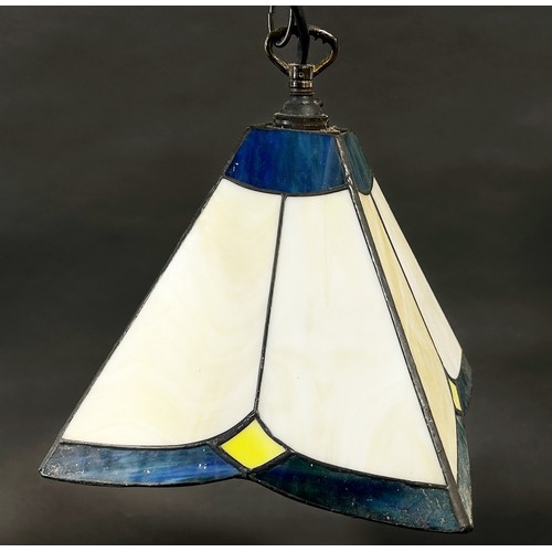 112 - A Tiffany style lamp with a conical shaped “lead” segmented glass shade and two pyramid Tiffany styl... 