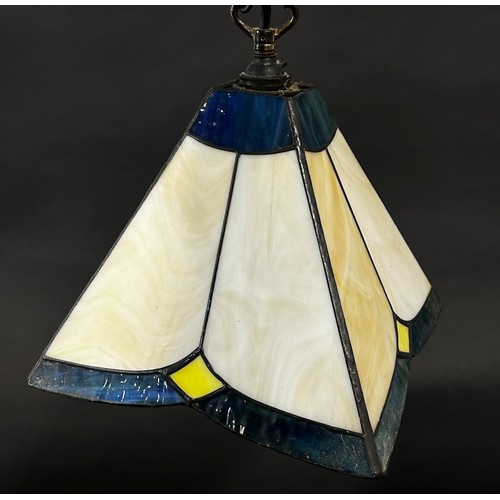 112 - A Tiffany style lamp with a conical shaped “lead” segmented glass shade and two pyramid Tiffany styl... 