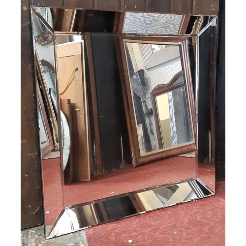 1300 - A contemporary art deco style wall mirror within a mirrored frame, 93cm x 93cm