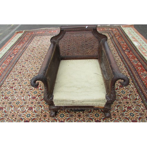 1456 - An good 19th century mahogany three piece bergere suite, the carved show wood frame with acanthus, s... 