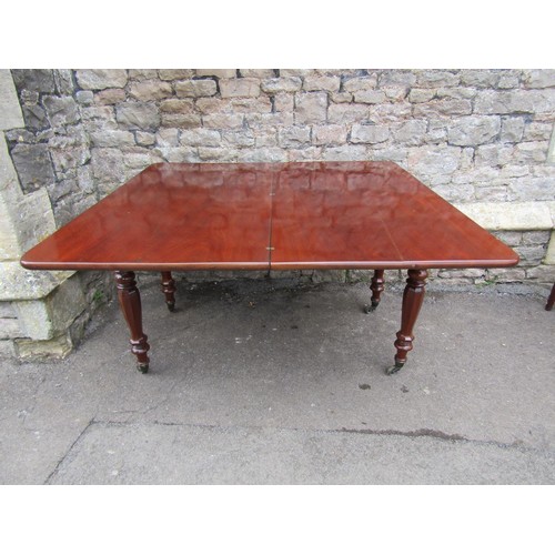 1402 - A 19th century mahogany mahogany fold over top dining table raised on four octagonal supports and ca... 