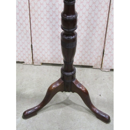 1153 - A mahogany torchere with reeded column on tripod legs