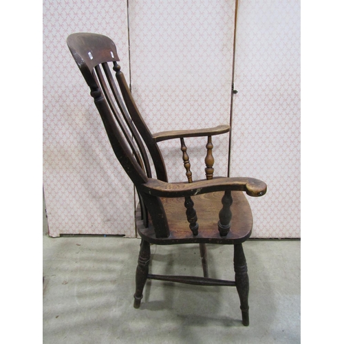 1234 - A Windsor lathe back elbow chair principally in elm and beech wood