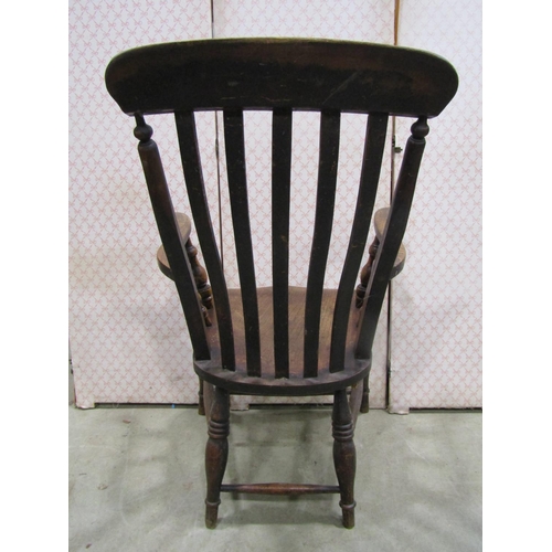 1234 - A Windsor lathe back elbow chair principally in elm and beech wood