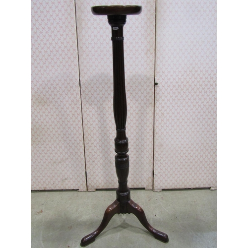 1153 - A mahogany torchere with reeded column on tripod legs