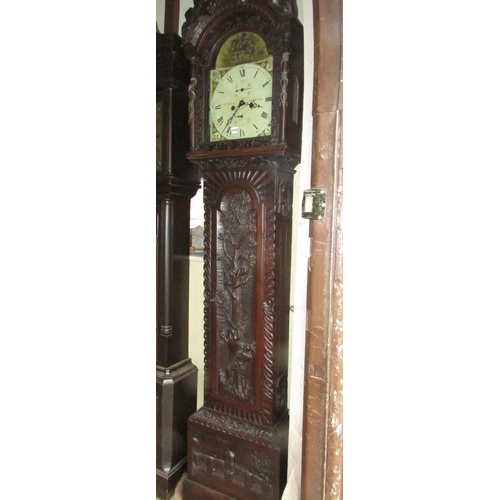 1310 - A 19th century oak longcase clock with heavy estate carving, the trunk detailing a knight fighting s... 