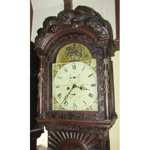 1310 - A 19th century oak longcase clock with heavy estate carving, the trunk detailing a knight fighting s... 