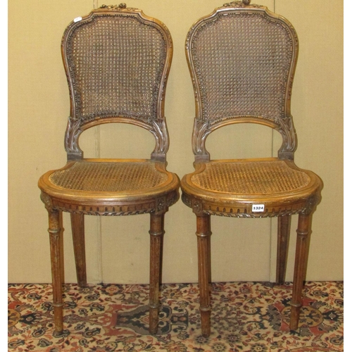 1324 - Pair of 19th century walnut side chairs with cane panelled seats and backs, floral and other carved ... 