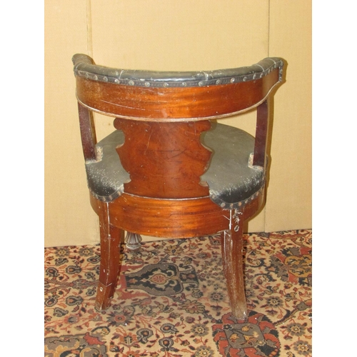 1327 - A 19th century mahogany library chair with carved splat, horseshoe shaped back and circular seat on ... 