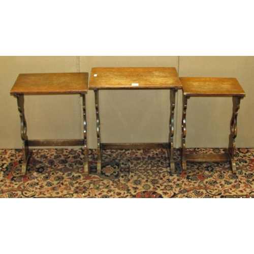 1334 - A nest of three old English style oak occasional tables with shaped supports, 46cm wide and smaller