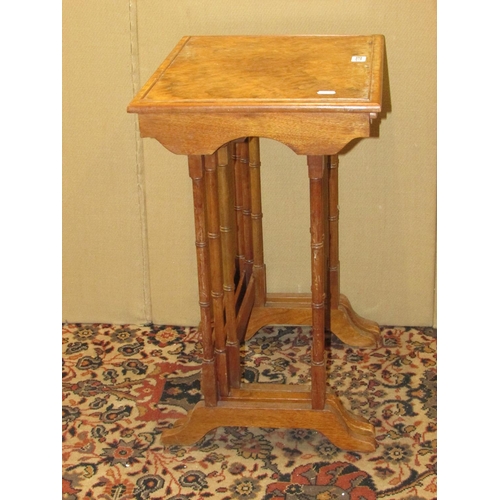 1338 - A nest of three Georgian style occasional tables, in walnut with figured walnut tops, 43cm wide max