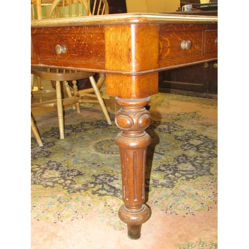 1344 - A Victorian oak writing desk with inset top over an arrangement of three real and three dummy drawer... 