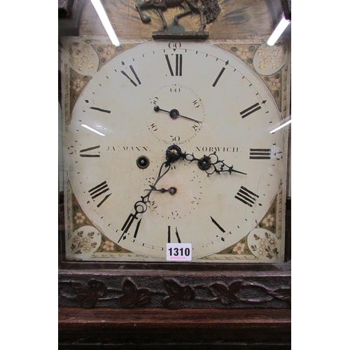 1310 - A 19th century oak longcase clock with heavy estate carving, the trunk detailing a knight fighting s... 