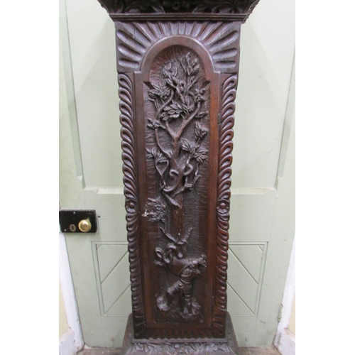 1310 - A 19th century oak longcase clock with heavy estate carving, the trunk detailing a knight fighting s... 