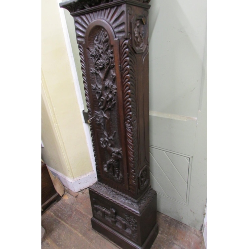 1310 - A 19th century oak longcase clock with heavy estate carving, the trunk detailing a knight fighting s... 