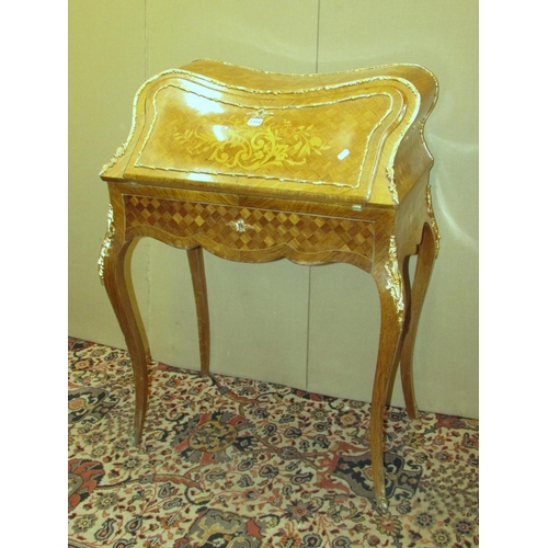 1354 - A French bureau du dame, with parquetry veneered finish, floral marquetry panel with over laid gilt ... 