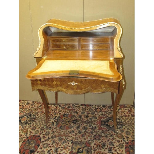 1354 - A French bureau du dame, with parquetry veneered finish, floral marquetry panel with over laid gilt ... 