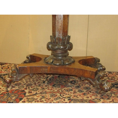 1356 - A Regency rose wood fold over top card table raised on an octagonal pillar with foliate column, the ... 