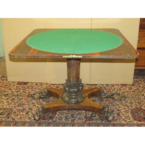 1356 - A Regency rose wood fold over top card table raised on an octagonal pillar with foliate column, the ... 