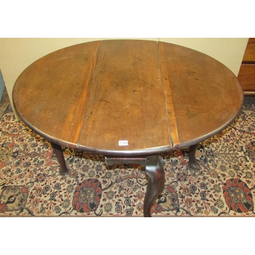 1366 - A small George III mahogany drop leaf table with frieze drawer, raised on four shaped supports with ... 