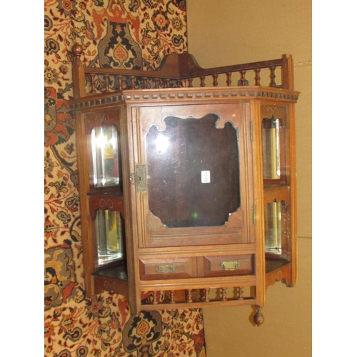 1379 - A late 19th century walnut hanging corner cupboard with mirrored recessed sides and spindle moulding... 