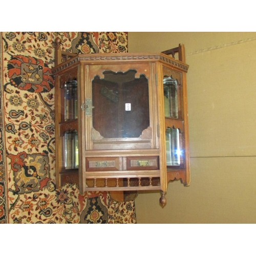 1379 - A late 19th century walnut hanging corner cupboard with mirrored recessed sides and spindle moulding... 