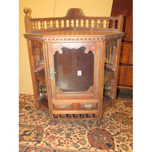 1379 - A late 19th century walnut hanging corner cupboard with mirrored recessed sides and spindle moulding... 