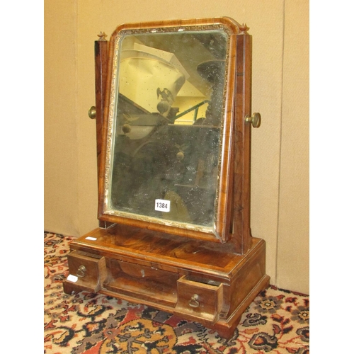 1384 - A Georgian walnut toilet mirror, the box base fitted with three drawers