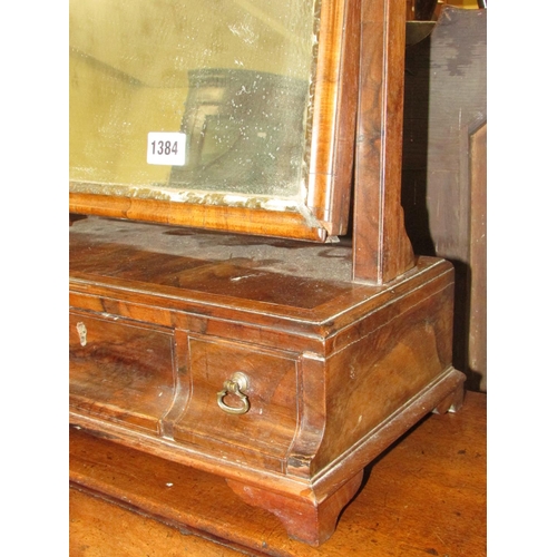 1384 - A Georgian walnut toilet mirror, the box base fitted with three drawers