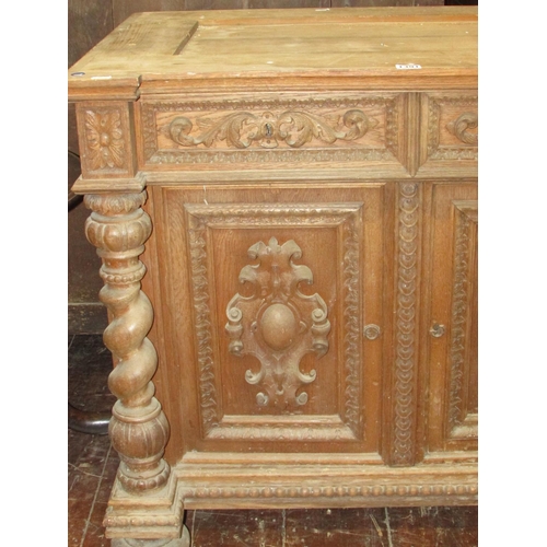 1391 - A 19th century oak side cupboard enclosed by two carved and panelled doors with two frieze drawers f... 