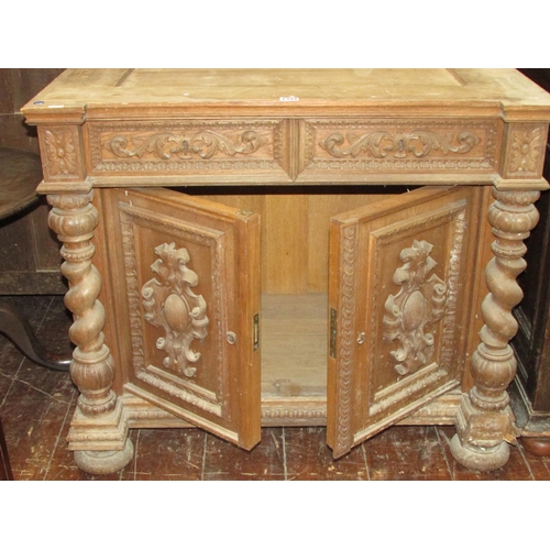 1391 - A 19th century oak side cupboard enclosed by two carved and panelled doors with two frieze drawers f... 