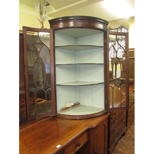 1398 - A Regency mahogany bow fronted hanging corner cupboard with astragal glazed panelled doors, original... 