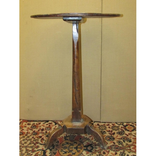 1400 - A simple Georgian countrymade occasional table in mixed woods, the oak top raised on a simple taperi... 