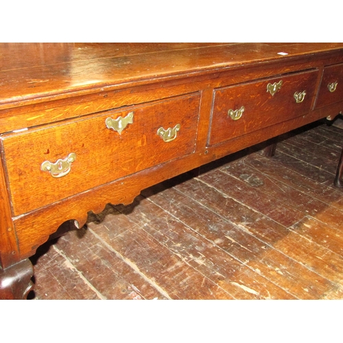 1407 - A Georgian oak dresser base fitted with three frieze drawers, shaped apron and shaped forelegs, 185c... 