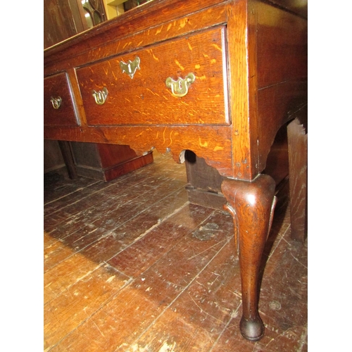 1407 - A Georgian oak dresser base fitted with three frieze drawers, shaped apron and shaped forelegs, 185c... 