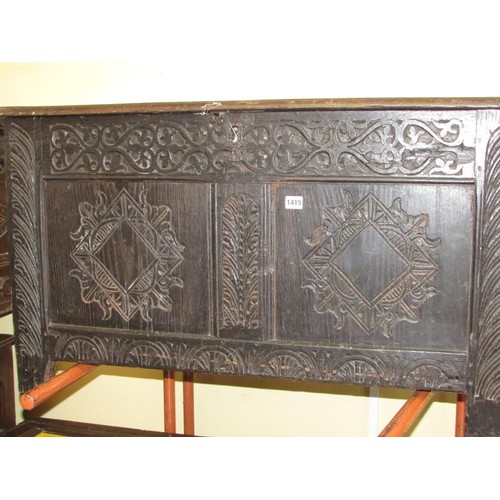 1415 - An 18th century oak coffer, the front elevation enclosed by two panels, with later geometric detail,... 