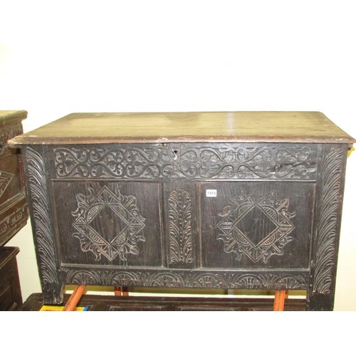 1415 - An 18th century oak coffer, the front elevation enclosed by two panels, with later geometric detail,... 