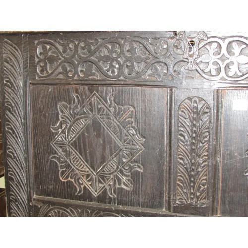 1415 - An 18th century oak coffer, the front elevation enclosed by two panels, with later geometric detail,... 