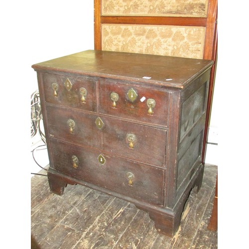 1429 - A small 18th century oak chest of two long and two drawers raised on bracket supports with pear drop... 