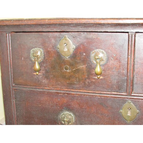 1429 - A small 18th century oak chest of two long and two drawers raised on bracket supports with pear drop... 