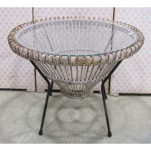 1243 - A vintage wicker two seat sofa, a mid century wicker plate glass occasional table of circular form a... 