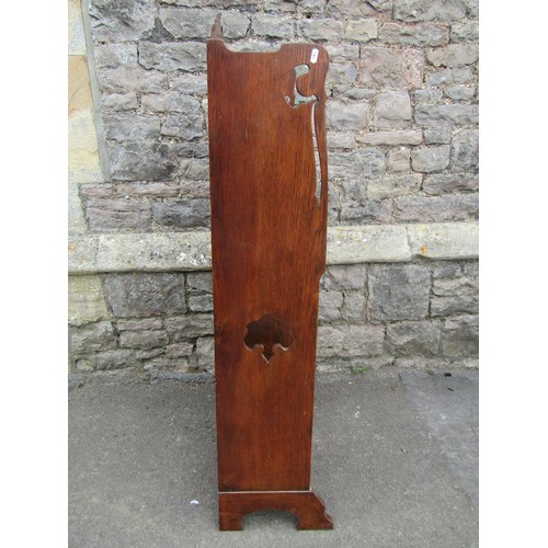 1121 - An early 20th century oak students bureau with strap hinges, the raised back with pierced detail of ... 