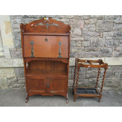 1121 - An early 20th century oak students bureau with strap hinges, the raised back with pierced detail of ... 