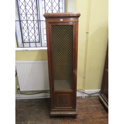 1370 - 19th century cupboard of square cut tapering form enclosed by a brass grilled door, 50cm wide