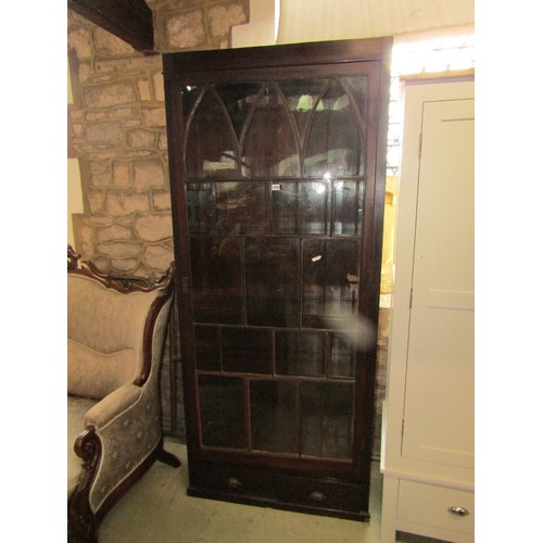 1256 - A 19th century mahogany bookcase of full height enclosed by an astragal glazed panelled door over tw... 