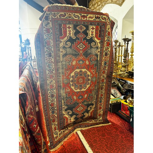 1484 - An old tribal Kazak Persian rug with an all over geometric pattern, worn in places, 204cm x 125cm ap... 