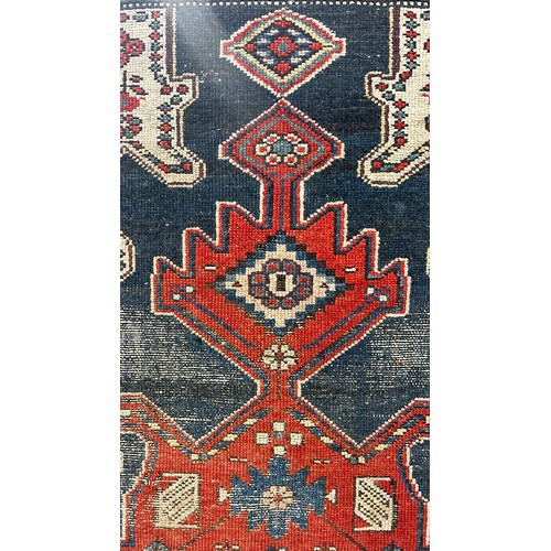 1484 - An old tribal Kazak Persian rug with an all over geometric pattern, worn in places, 204cm x 125cm ap... 