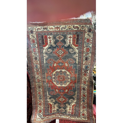 1484 - An old tribal Kazak Persian rug with an all over geometric pattern, worn in places, 204cm x 125cm ap... 