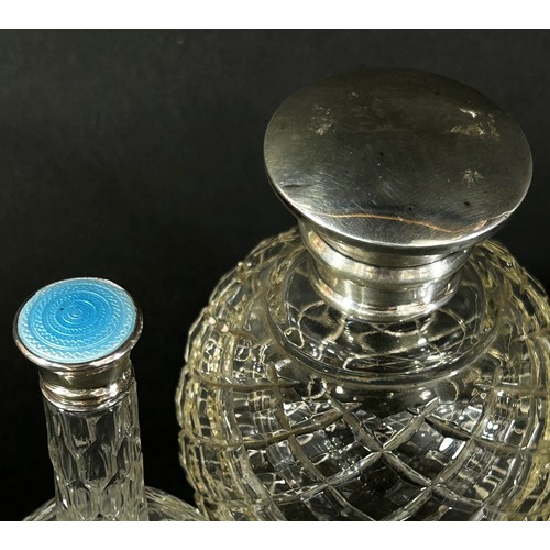 206 - A silver capped glass dressing table bottle London 1925 and a small glass perfume bottle with a silv... 